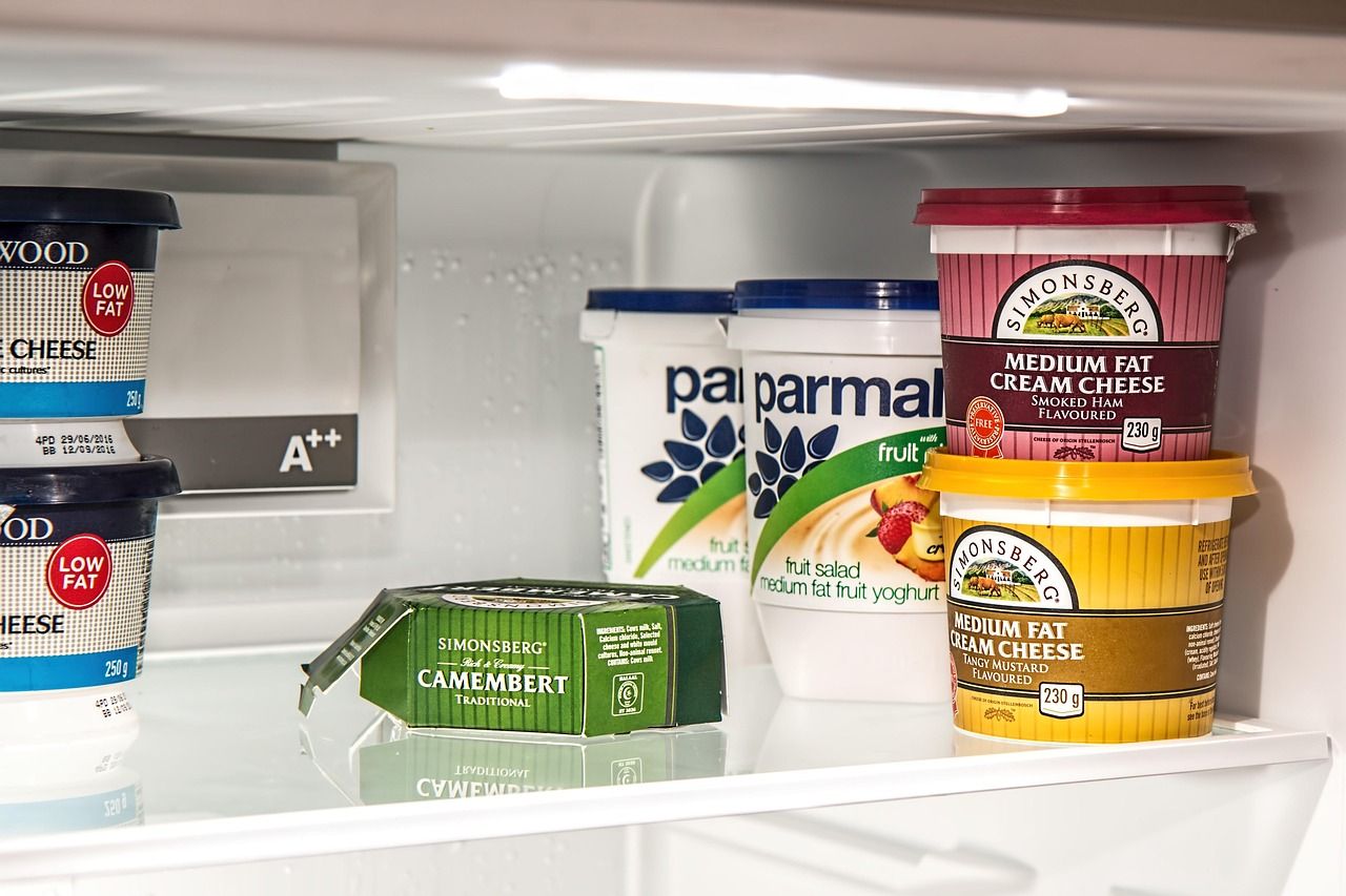 An open refrigerator stocked with food and drinks
