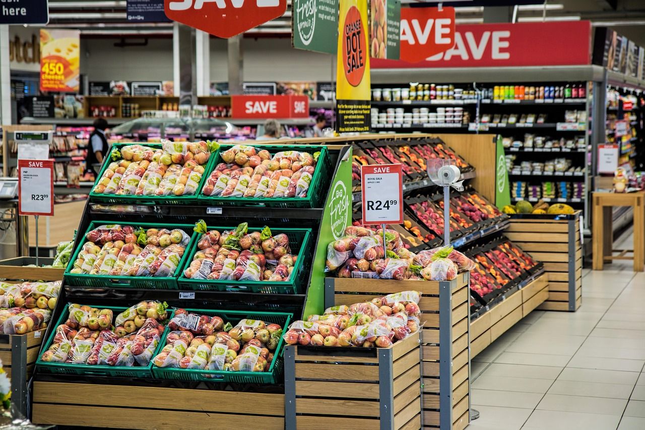 A shopping basket filled with fresh produce in a grocery store