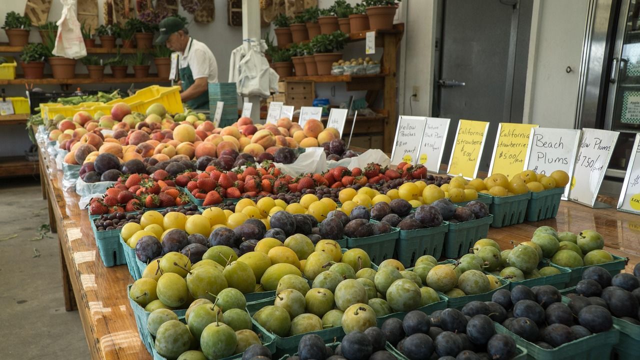 Fresh fruit and vegetables displayed at a farmers market stand