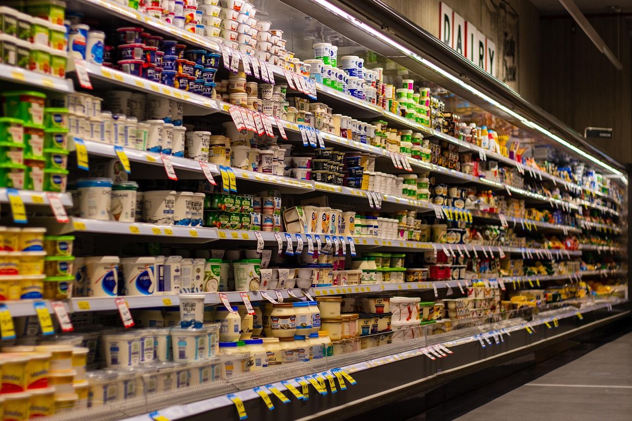 Rows of dairy products lined up on a supermarket shelf