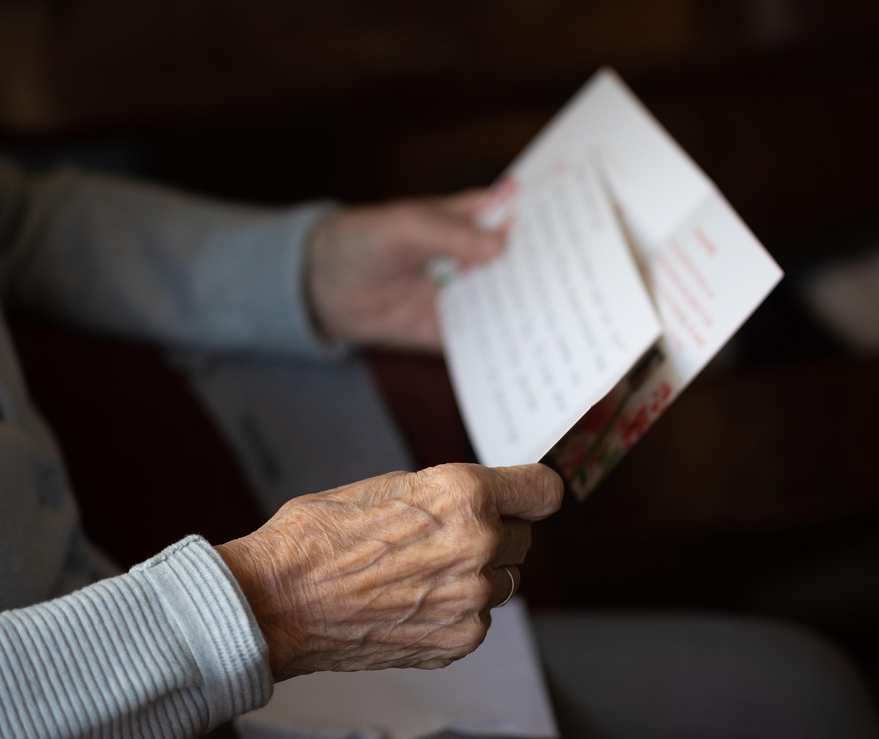An older person's hands holding a letter