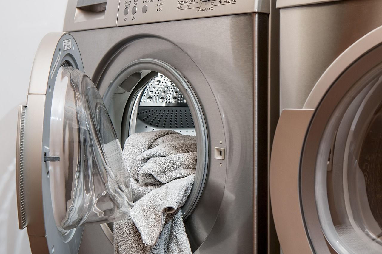 A washing machine mid-cycle with towels inside