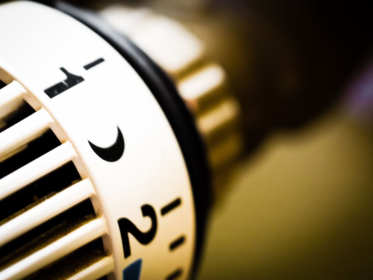 Close-up of a radiator thermostat dial being adjusted